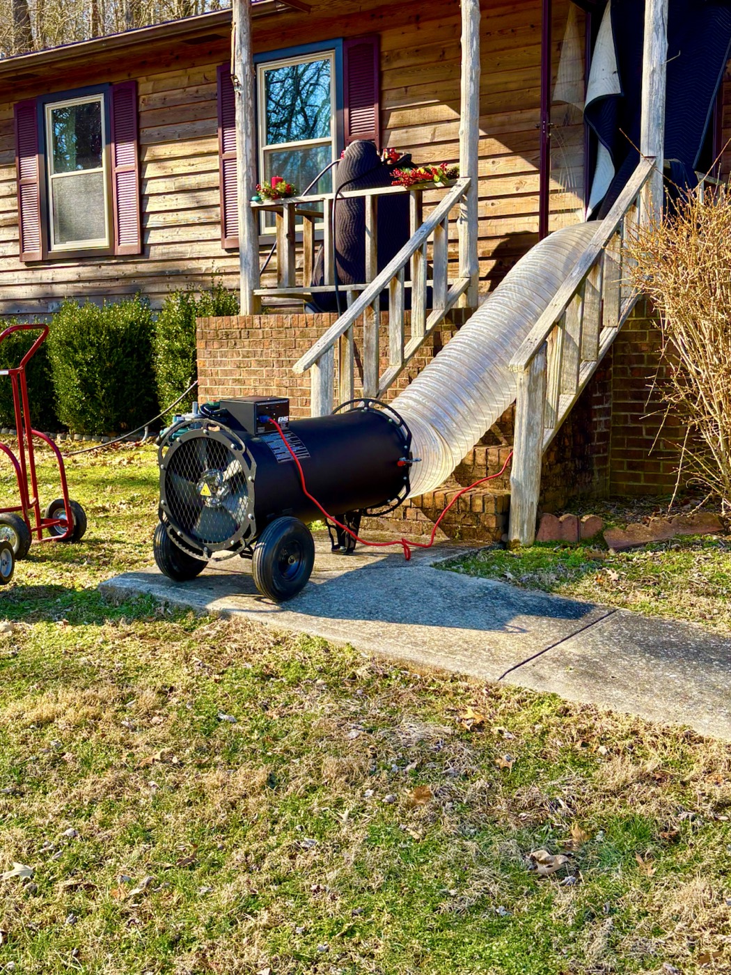 EcoForce treatment hose routed up porch steps to a home entry